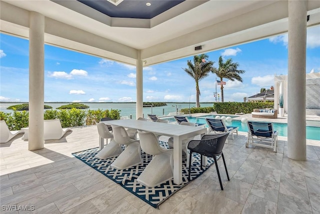 view of patio featuring a water view and an outdoor pool