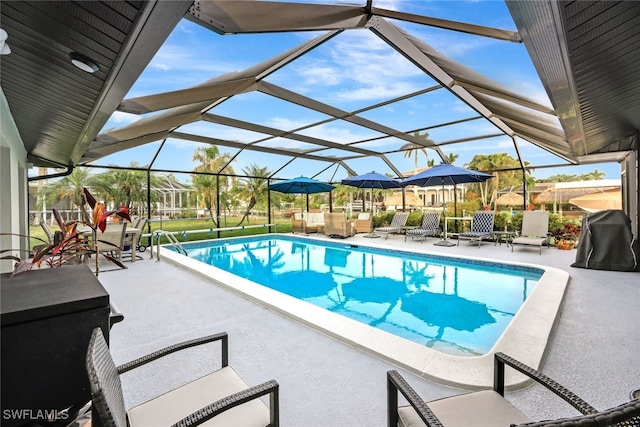 outdoor pool with a lanai and a patio