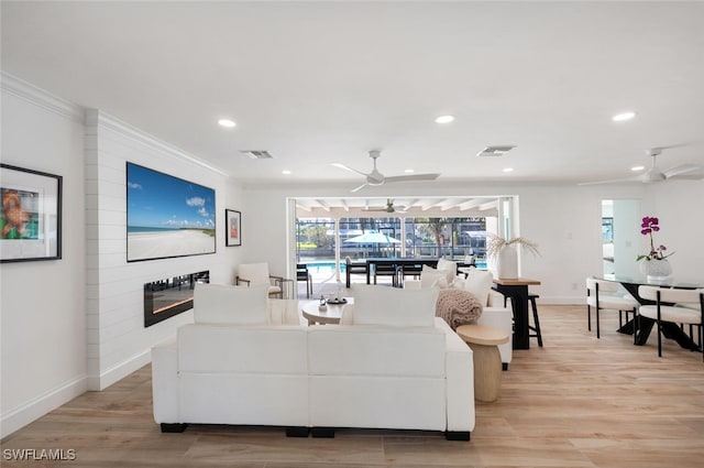 418 Germain Ave, Naples, FL 34108 - living room featuring a ceiling fan, a large fireplace, baseboards, recessed lighting, and crown molding