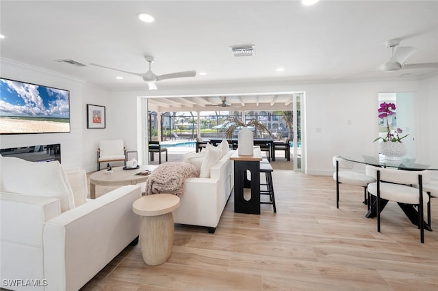 418 Germain Ave, Naples, FL 34108 - living room with ceiling fan, recessed lighting, light wood-type flooring, ornamental molding, and baseboards