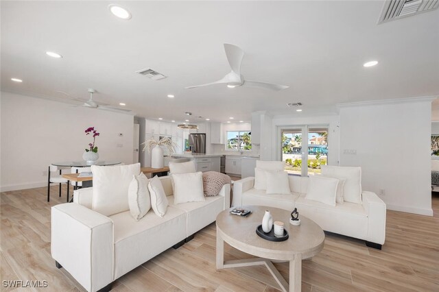 418 Germain Ave, Naples, FL 34108 - living room featuring a ceiling fan, recessed lighting, ornamental molding, baseboards, and light wood finished floors