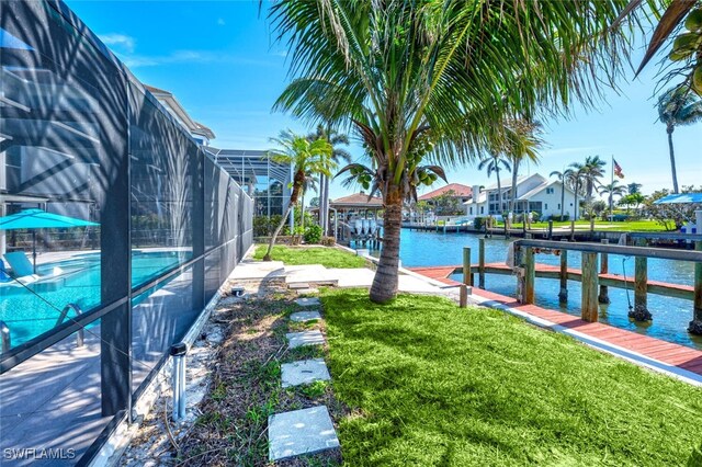 418 Germain Ave, Naples, FL 34108 - dock area with a yard, an outdoor pool, a water view, and a lanai