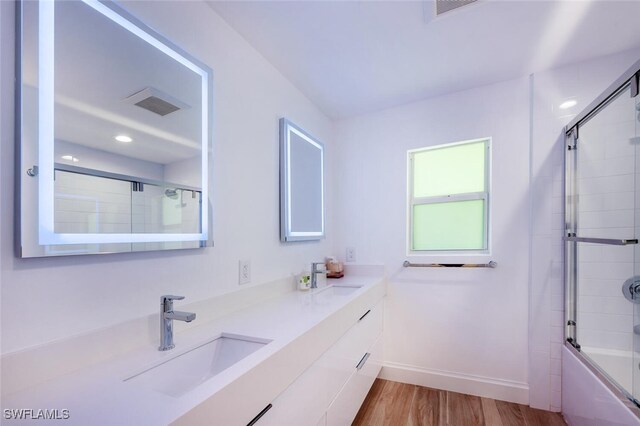 418 Germain Ave, Naples, FL 34108 - full bathroom with vanity, shower / bath combination with glass door, wood finished floors, baseboards, and recessed lighting