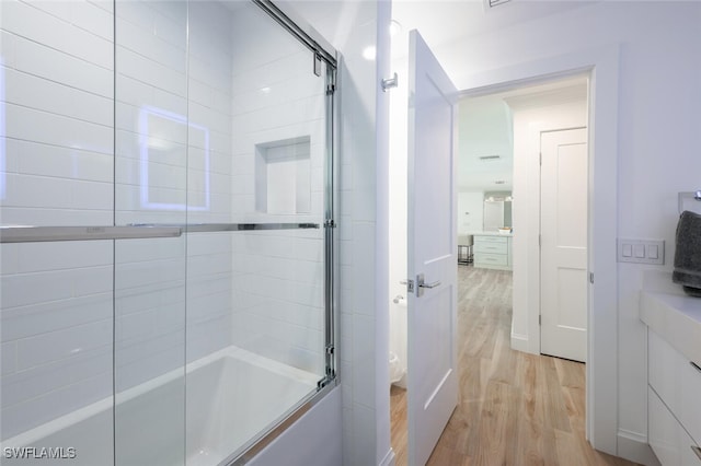 418 Germain Ave, Naples, FL 34108 - full bathroom with wood finished floors and combined bath / shower with glass door