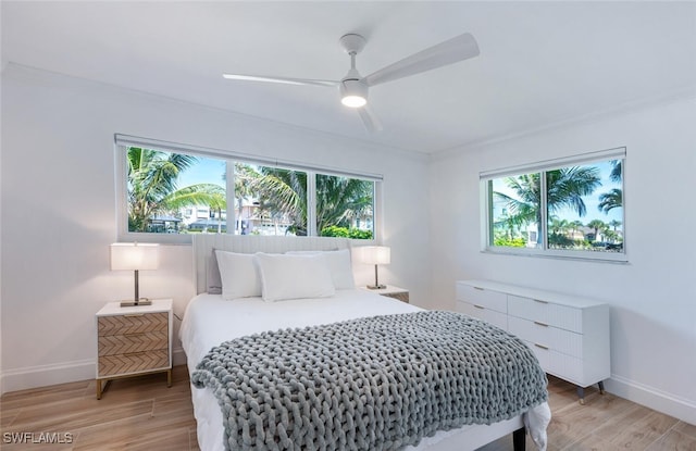 418 Germain Ave, Naples, FL 34108 - bedroom with crown molding, baseboards, light wood finished floors, and a ceiling fan