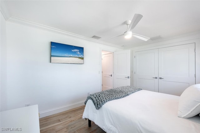 418 Germain Ave, Naples, FL 34108 - bedroom featuring wood finished floors, baseboards, crown molding, a closet, and a ceiling fan