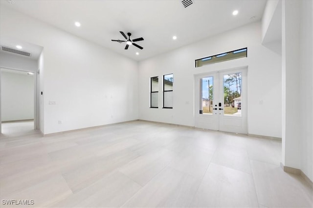 unfurnished living room with recessed lighting, visible vents, a ceiling fan, and french doors