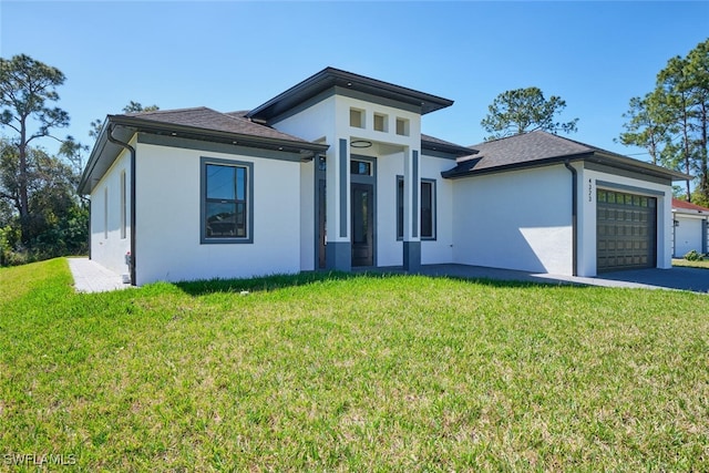 prairie-style home with stucco siding, driveway, a front lawn, and an attached garage