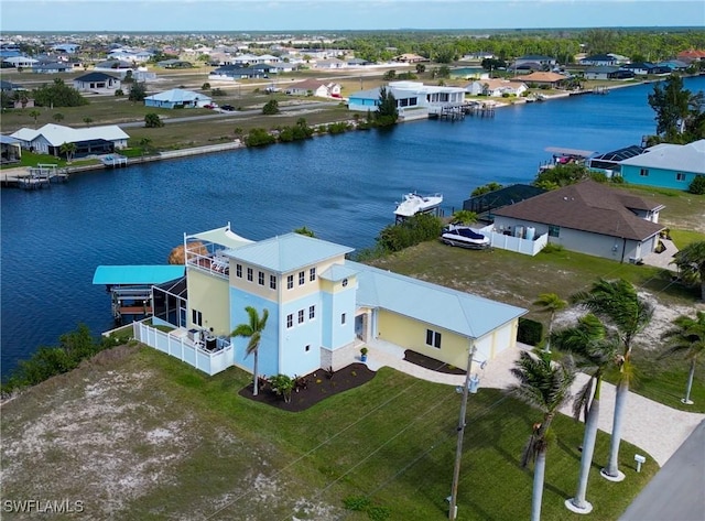 birds eye view of property with a residential view and a water view