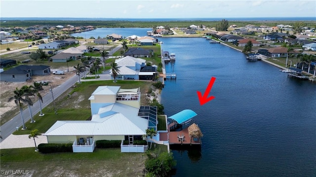 bird's eye view featuring a residential view and a water view