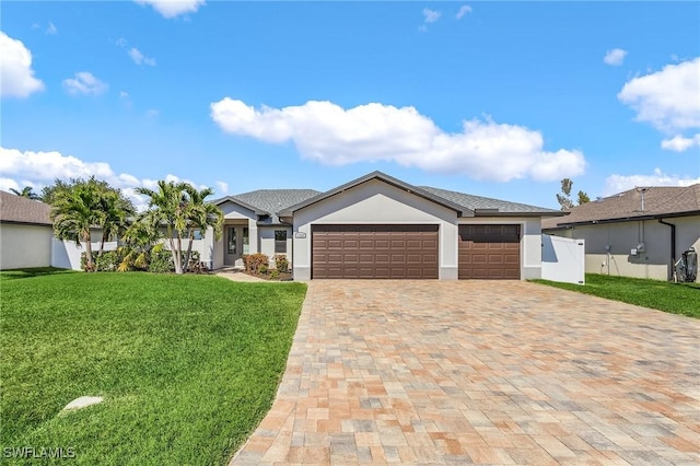 ranch-style home with a garage and a front yard