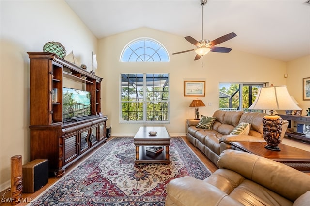 12206 Siesta Dr, Fort Myers Beach, FL 33931 - living room featuring lofted ceiling, plenty of natural light, wood finished floors, and ceiling fan