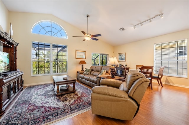 12206 Siesta Dr, Fort Myers Beach, FL 33931 - living area featuring lofted ceiling, wood finished floors, plenty of natural light, and a ceiling fan