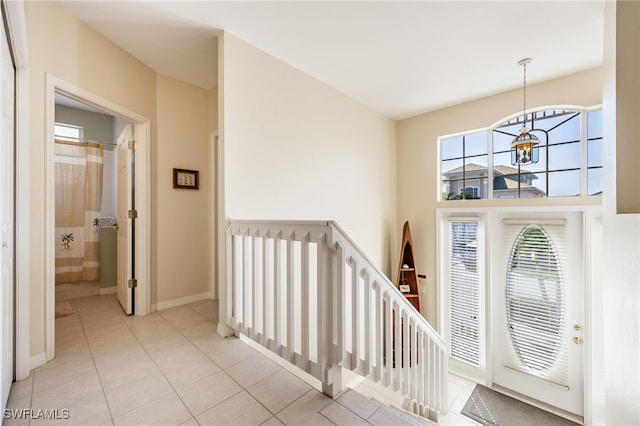 12206 Siesta Dr, Fort Myers Beach, FL 33931 - entrance foyer with a chandelier and light tile patterned floors