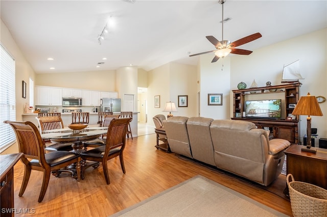 12206 Siesta Dr, Fort Myers Beach, FL 33931 - dining area featuring light wood-style floors, lofted ceiling, a ceiling fan, recessed lighting, and rail lighting