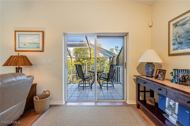 12206 Siesta Dr, Fort Myers Beach, FL 33931 - doorway to outside featuring baseboards and wood finished floors