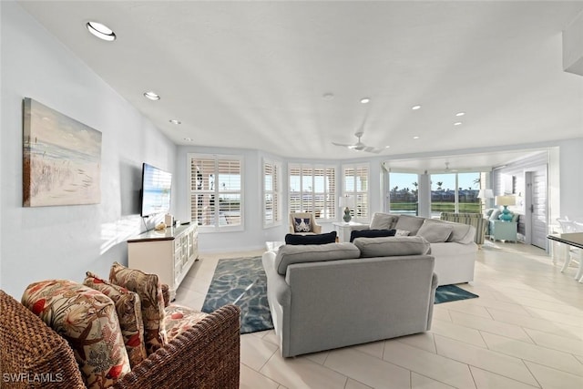 living area with light tile patterned floors, ceiling fan, and recessed lighting