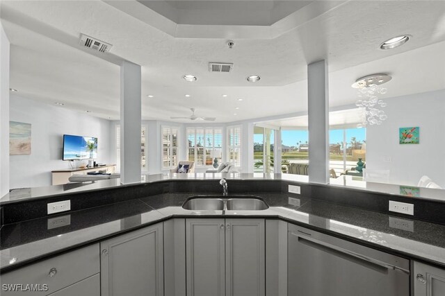 kitchen featuring dishwasher, visible vents, open floor plan, and a sink