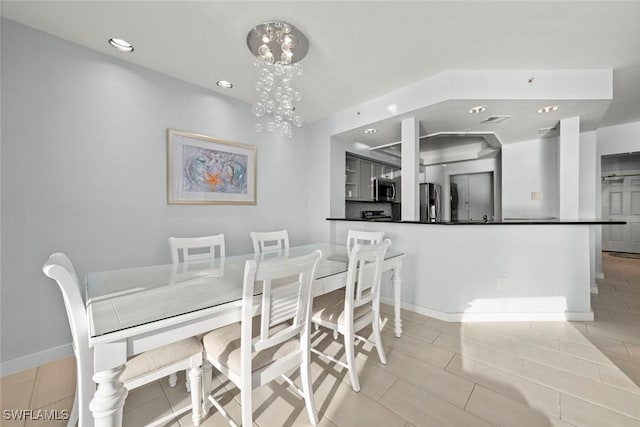 dining area featuring a chandelier, recessed lighting, light tile patterned flooring, and baseboards