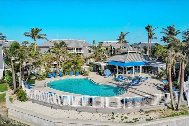 pool featuring a patio area and fence