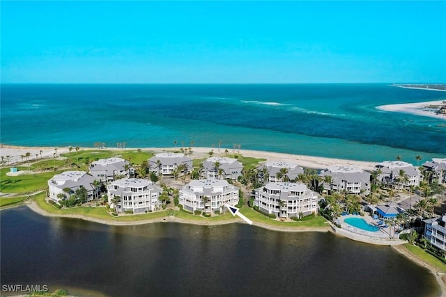 bird's eye view featuring a water view and a view of the beach