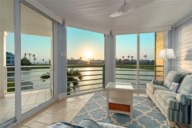 sunroom featuring wood ceiling, a water view, and a wealth of natural light