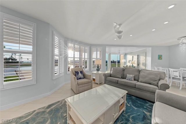 tiled living room with baseboards, recessed lighting, and a healthy amount of sunlight