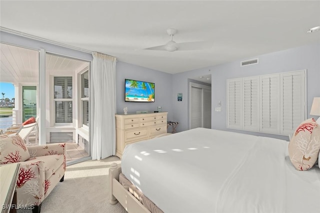 carpeted bedroom with ceiling fan, access to outside, a closet, and visible vents