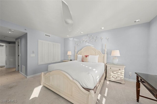 bedroom with carpet floors, baseboards, and visible vents