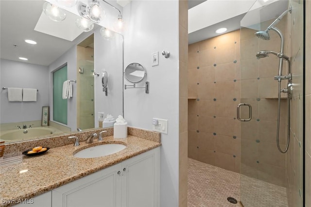 full bath featuring a stall shower, vanity, and recessed lighting