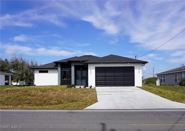 view of front of home featuring a garage and a front yard