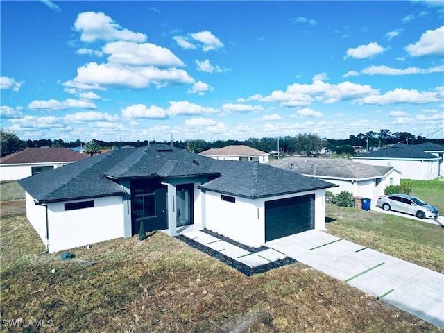 view of front of house with a garage and a front yard