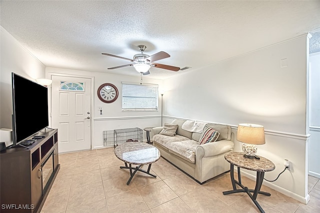 905 Lucas Rd, Fort Myers, FL 33919 - living area featuring ceiling fan, a textured ceiling, and light tile patterned floors