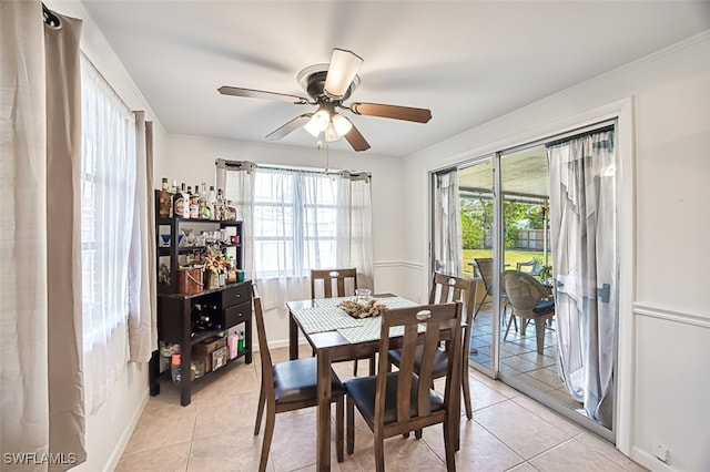 dining area featuring ceiling fan, light tile patterned floors, and a healthy amount of sunlight