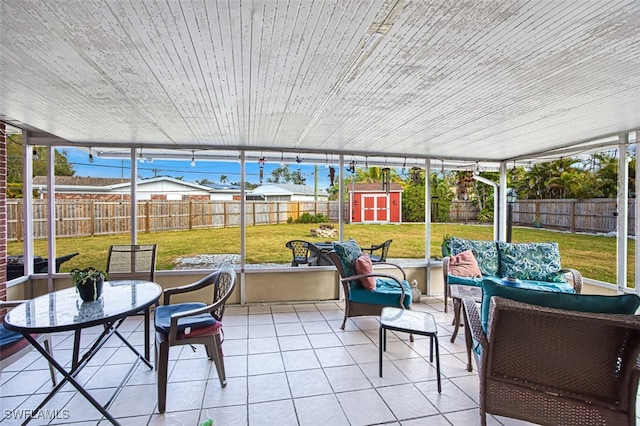 sunroom featuring plenty of natural light, outdoor lounge area, and outdoor dining space