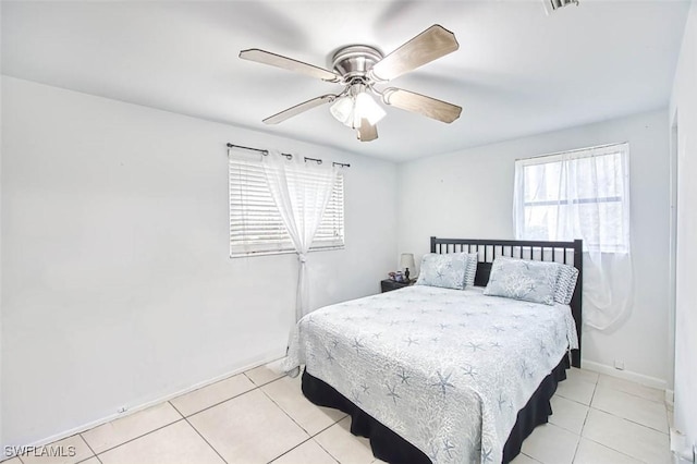 bedroom featuring light tile patterned flooring, baseboards, and a ceiling fan
