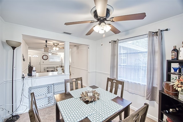 dining room with visible vents, ornamental molding, and ceiling fan