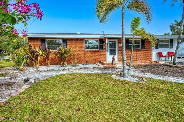 ranch-style home with brick siding and a front lawn