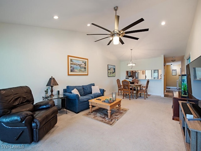 living area with ceiling fan, recessed lighting, light carpet, baseboards, and vaulted ceiling