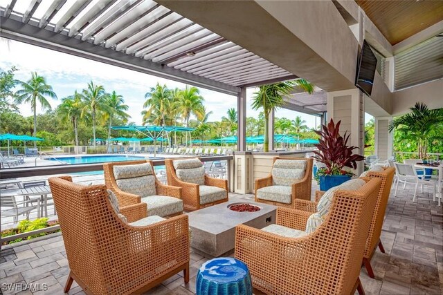 view of patio with a fire pit and a community pool