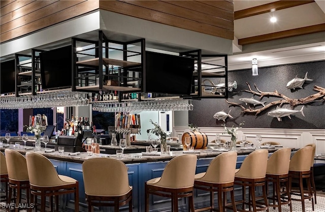 bar featuring wainscoting and wet bar
