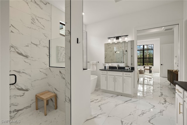 bathroom with marble finish floor, a soaking tub, vanity, and a marble finish shower