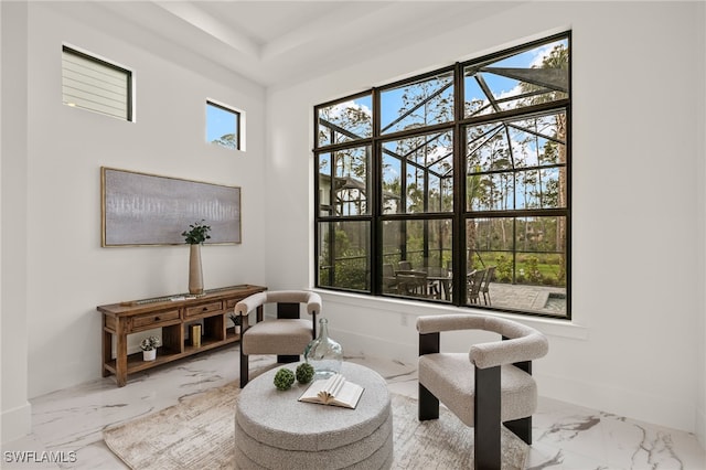 living area with marble finish floor and baseboards