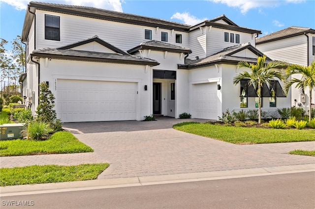 view of front of home featuring a garage and decorative driveway