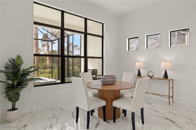 dining room with marble finish floor and baseboards