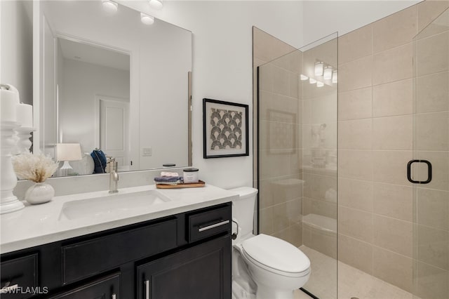 full bath featuring toilet, a shower stall, and vanity