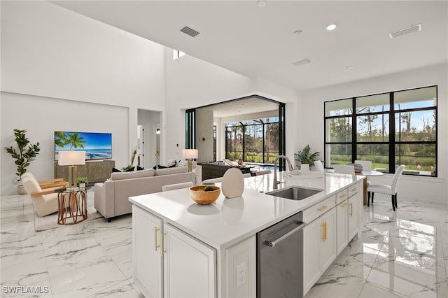 kitchen with a sink, white cabinetry, light countertops, marble finish floor, and dishwasher