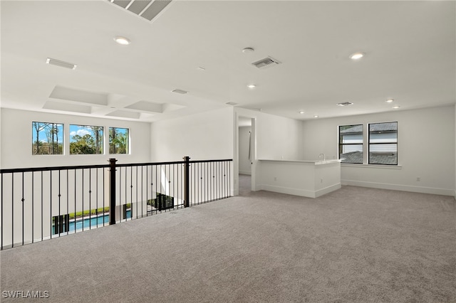 spare room with visible vents, light colored carpet, and a healthy amount of sunlight