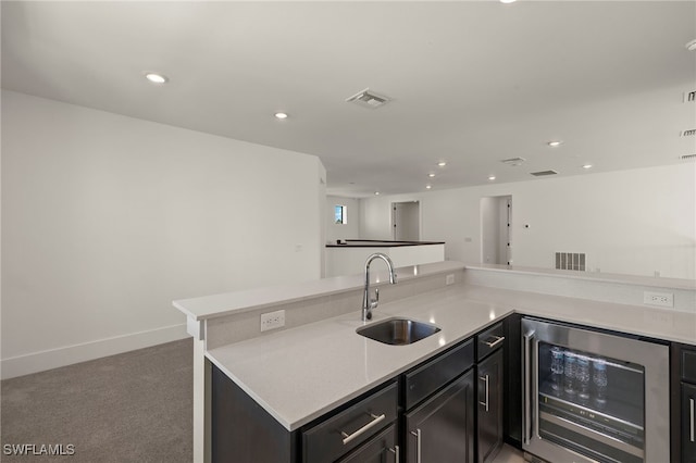 kitchen with wine cooler, a sink, visible vents, and recessed lighting