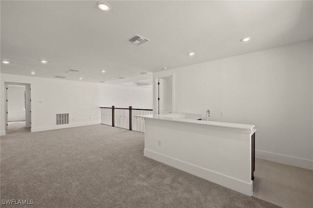 spare room featuring light colored carpet, recessed lighting, and visible vents